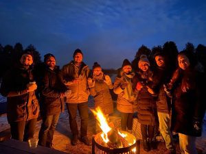 friends gathered around private fire pit at West Avenue Cider House
