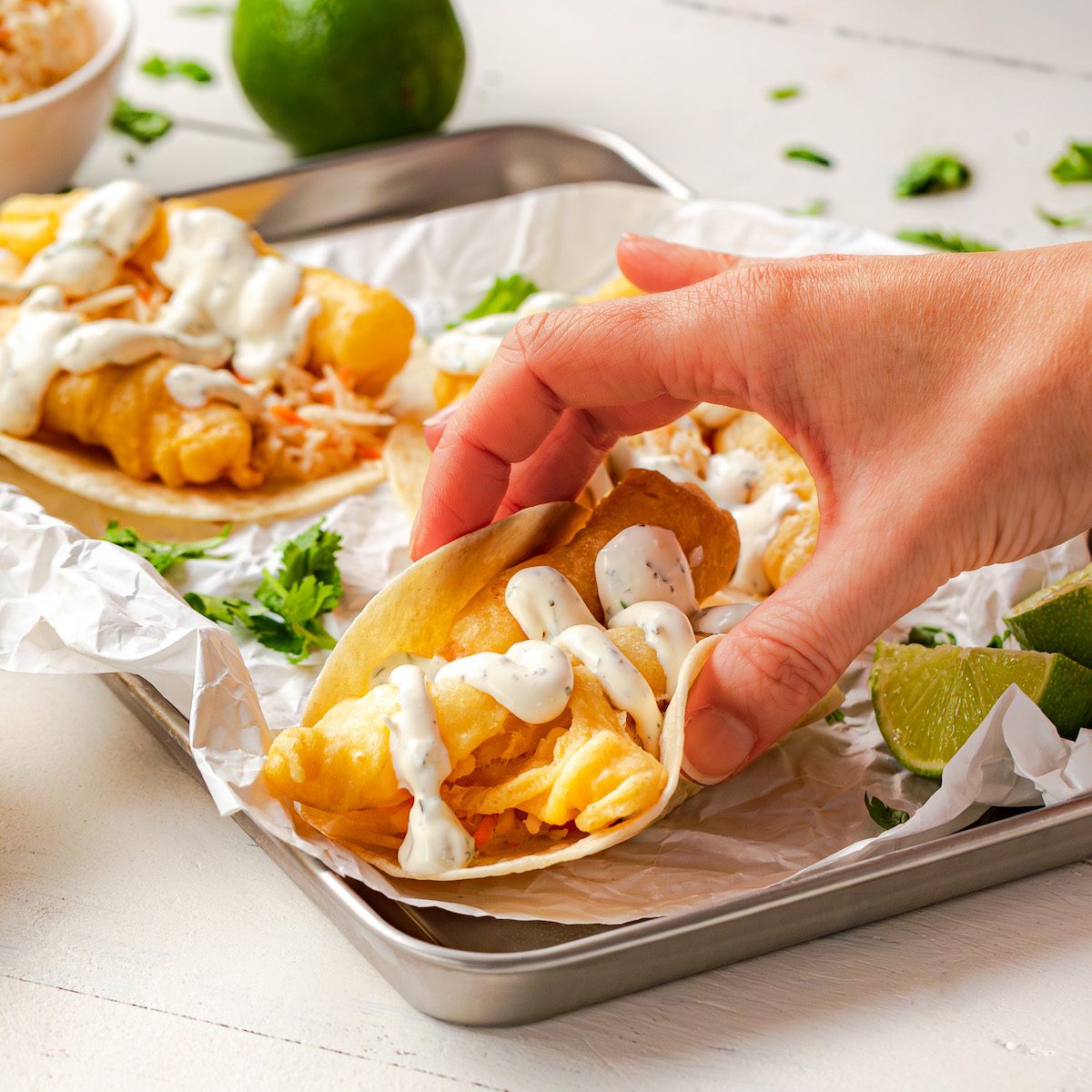 a hand holding a fish taco in Hastings County