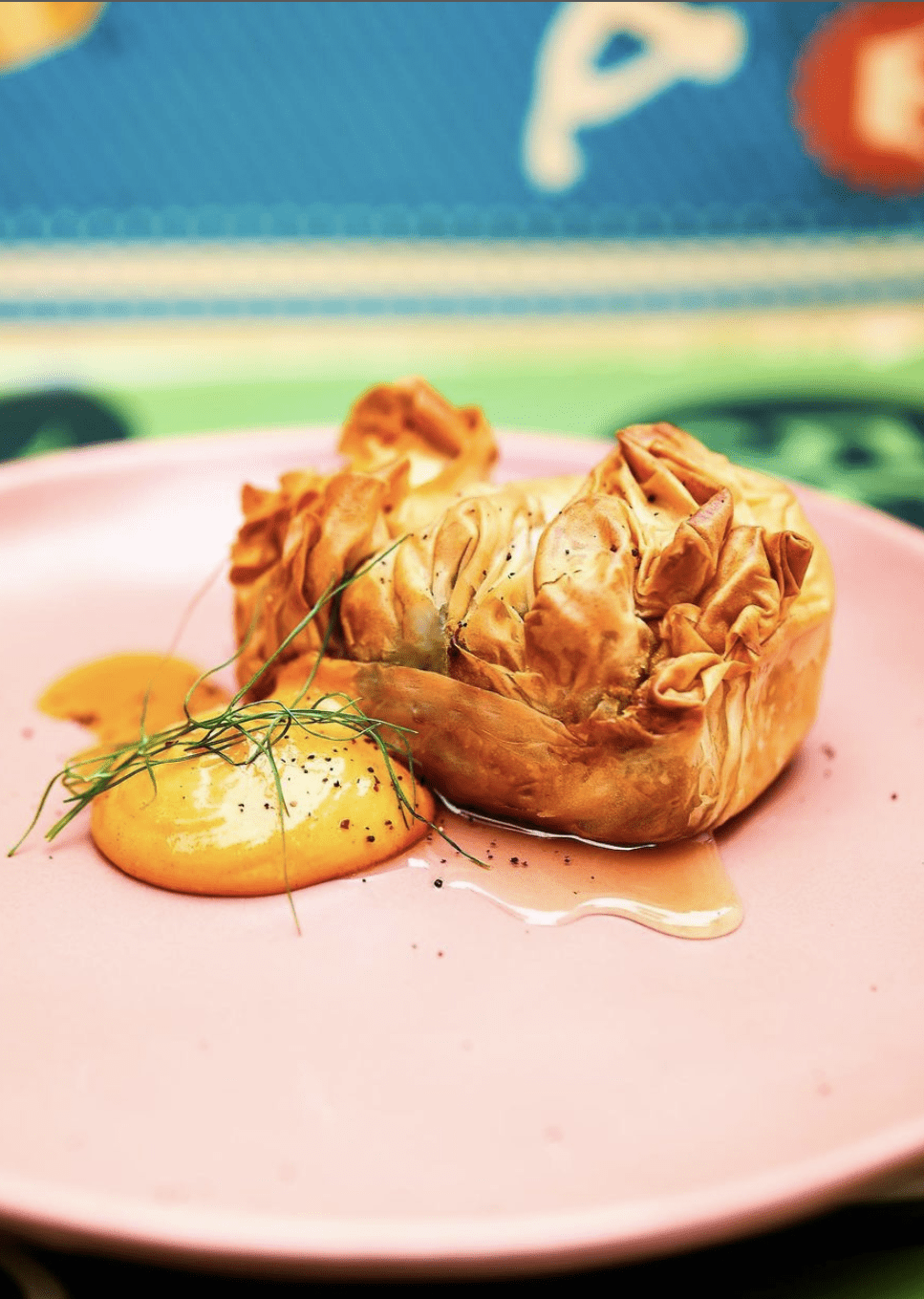 close up of a dish from ricky and olivia on a pink plate